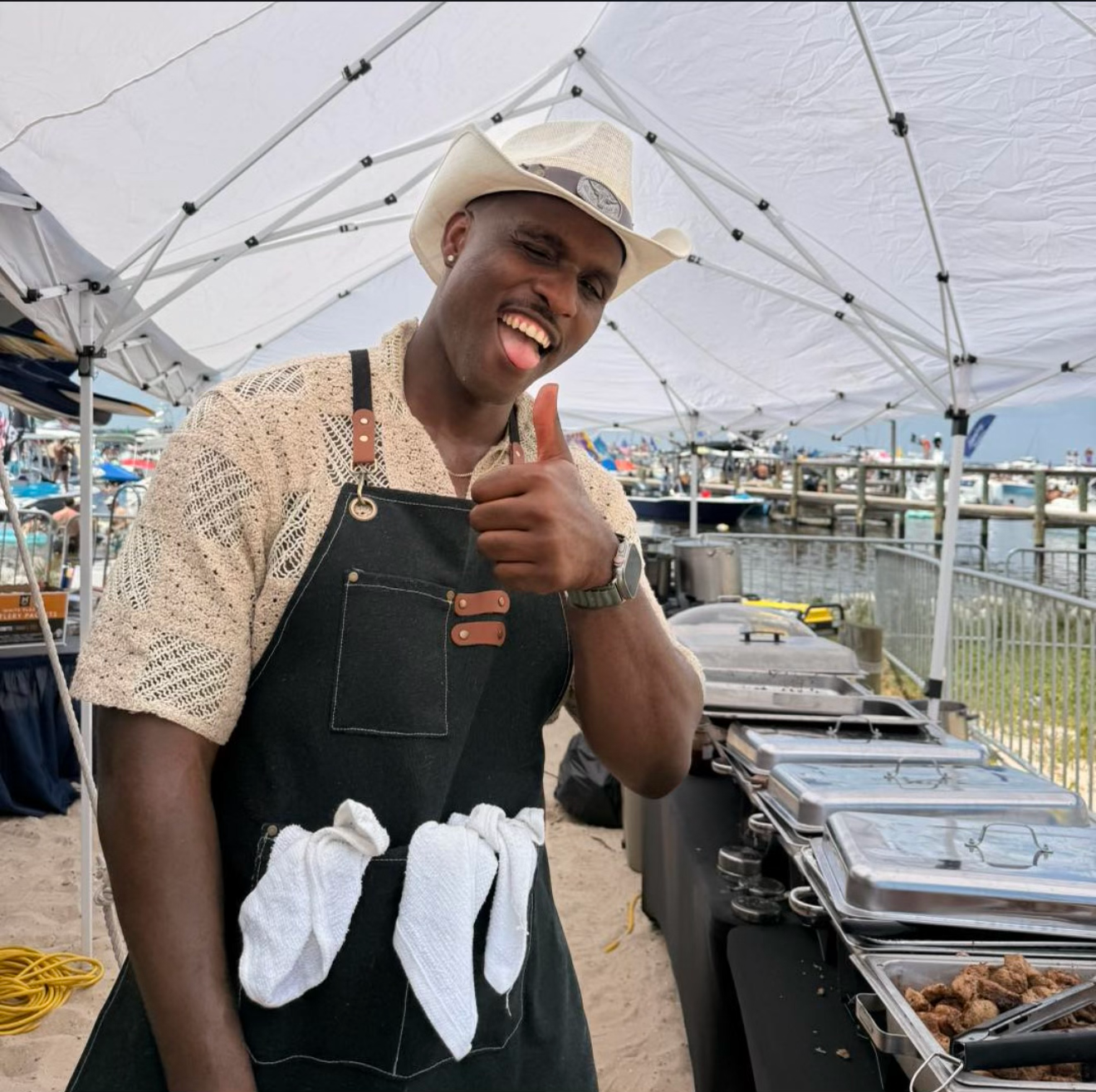 The Woodfyah chef smiling at an outdoor catering event