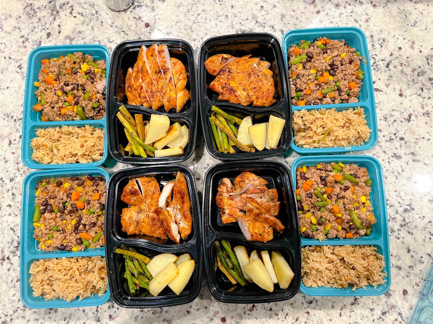 Prepared meals with sliced chicken, rice, asparagus, potatoes, and vegetables